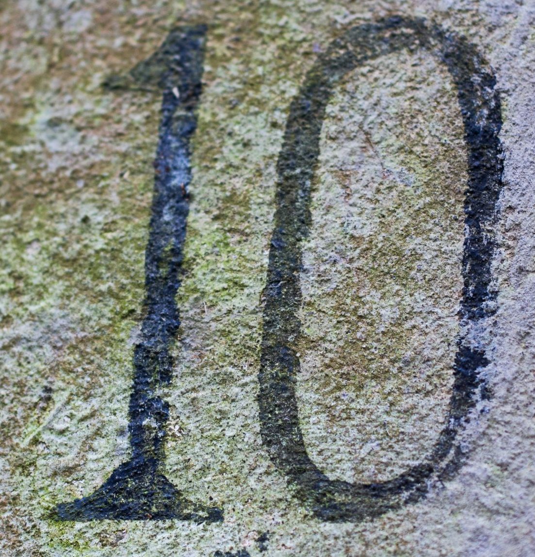 a close up of a number on a rock